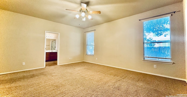 spare room featuring ceiling fan, plenty of natural light, and carpet floors