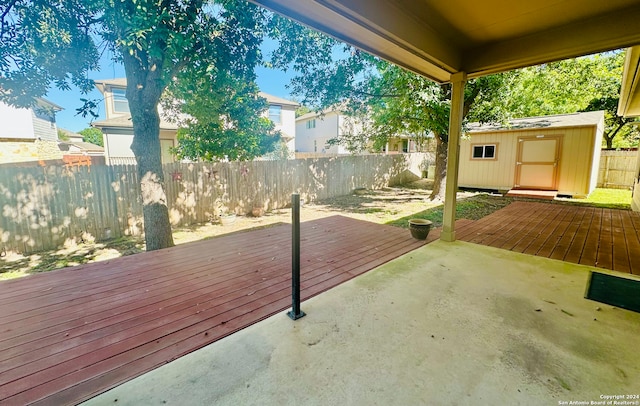 view of patio with a shed and a wooden deck