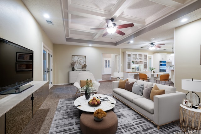 living room featuring coffered ceiling, crown molding, carpet flooring, ceiling fan, and beam ceiling