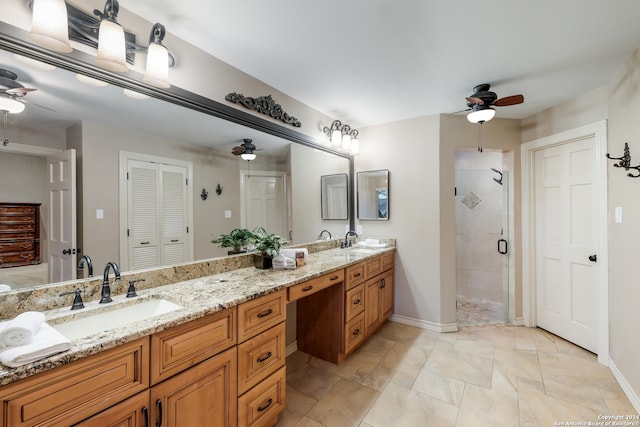 bathroom featuring vanity, ceiling fan, and a shower with shower door