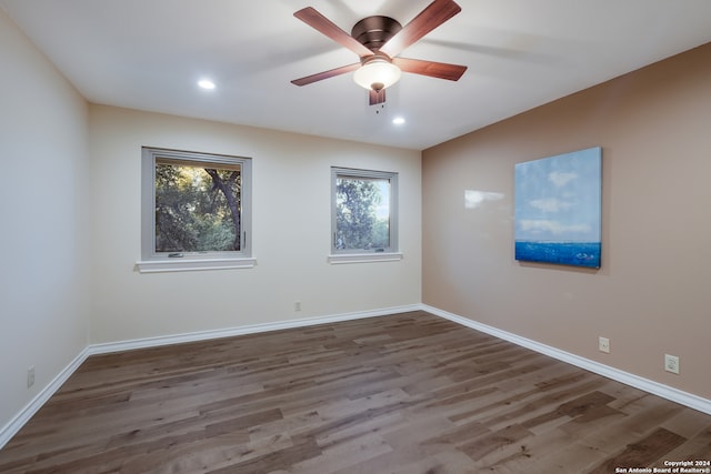 unfurnished room featuring ceiling fan and dark wood-type flooring