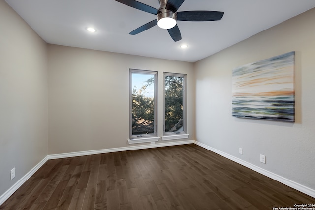 unfurnished room with dark hardwood / wood-style floors and ceiling fan