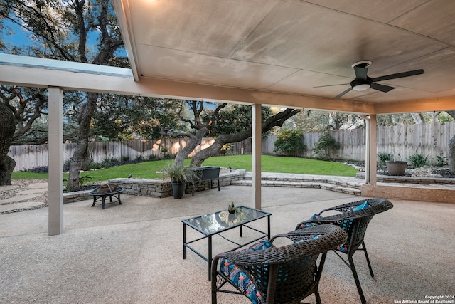 view of patio with an outdoor fire pit and ceiling fan