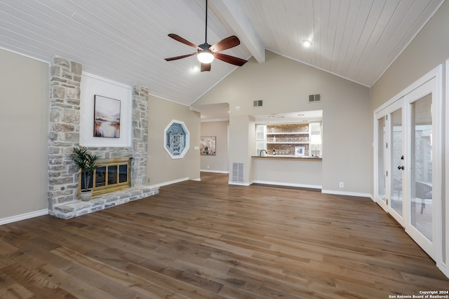 unfurnished living room with dark hardwood / wood-style floors, ceiling fan, a stone fireplace, and french doors