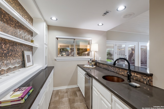 bathroom featuring vanity, backsplash, and hardwood / wood-style flooring