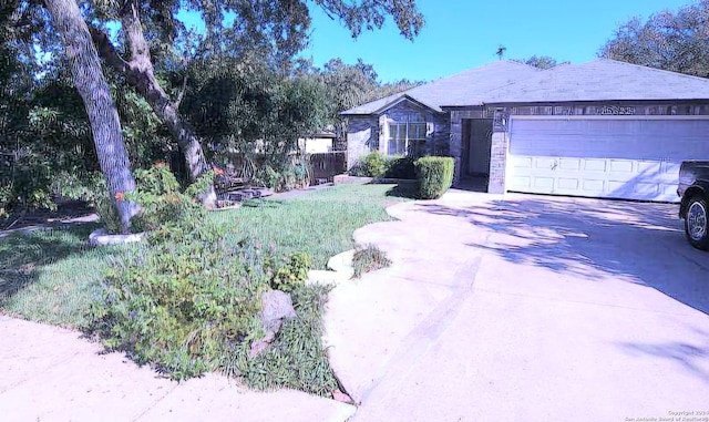 single story home with a front yard and a garage