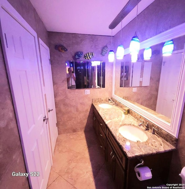 15822 Lomita Springs Dr, San Antonio, TX 78247 - full bathroom featuring double vanity, tile patterned floors, and tile walls
