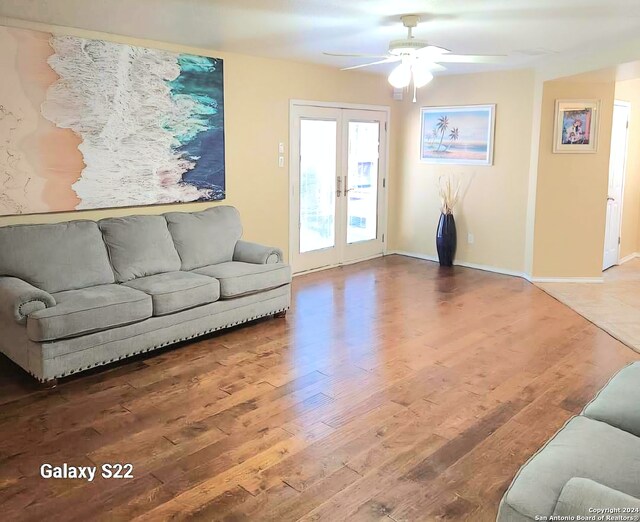 living room with ceiling fan, wood-type flooring, and french doors