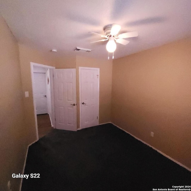 unfurnished bedroom featuring ceiling fan