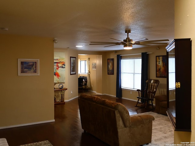 15822 Lomita Springs Dr, San Antonio, TX 78247 - living room featuring ceiling fan, baseboards, wood finished floors, and a textured ceiling