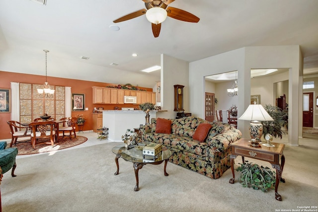 living room with ceiling fan with notable chandelier and light colored carpet