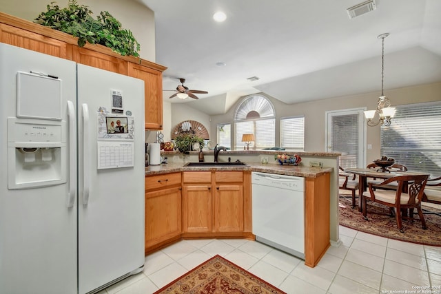 kitchen with ceiling fan with notable chandelier, white appliances, vaulted ceiling, sink, and light tile patterned floors