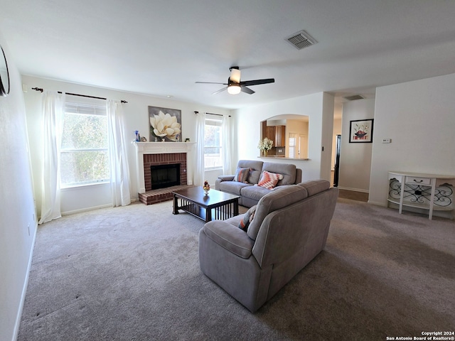 living room with carpet flooring, a fireplace, and plenty of natural light