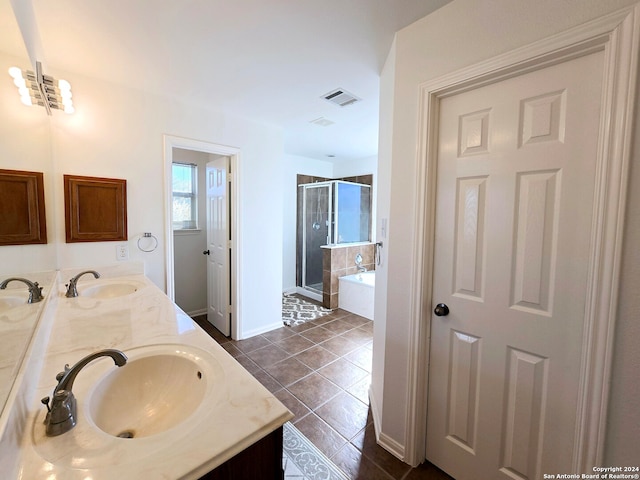 bathroom with tile patterned floors, vanity, and independent shower and bath