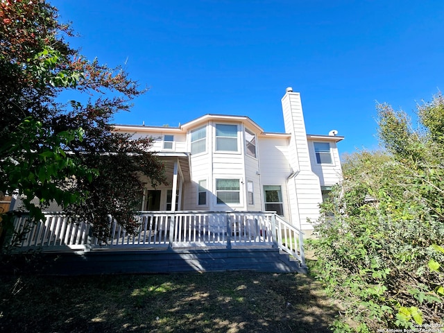 back of property featuring a deck