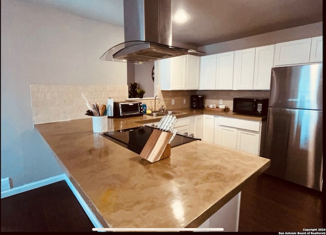 kitchen featuring backsplash, black appliances, sink, white cabinetry, and island exhaust hood