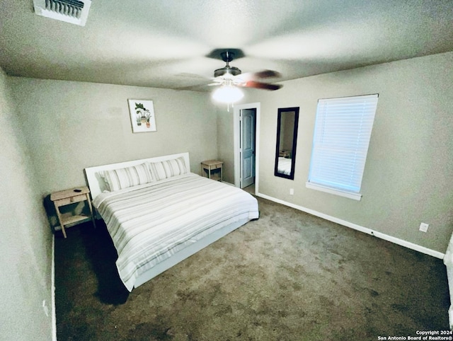 unfurnished bedroom featuring dark carpet and ceiling fan