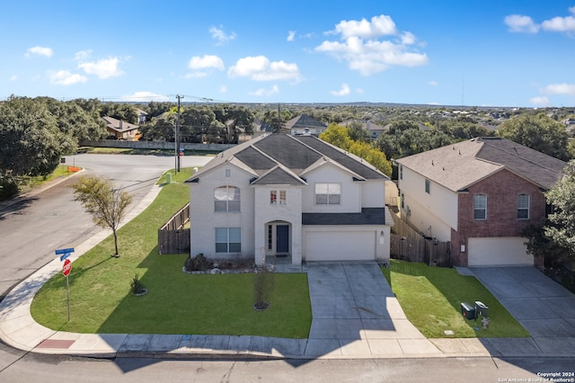 view of front of property with a front yard and a garage