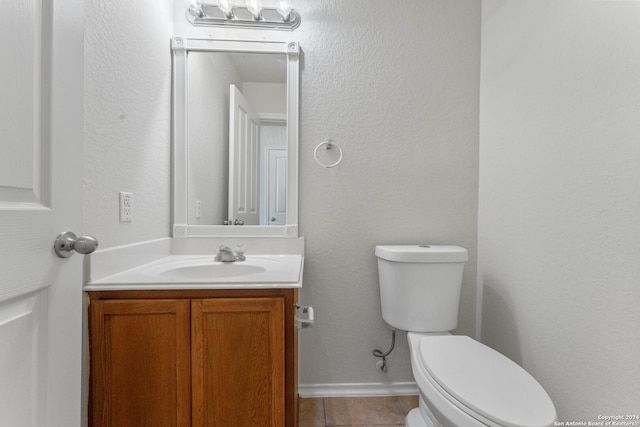 bathroom with tile patterned flooring, vanity, and toilet