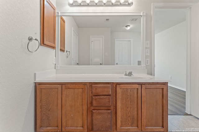 bathroom with hardwood / wood-style floors and vanity