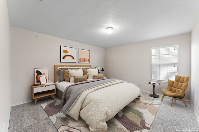 bedroom featuring carpet flooring and a textured ceiling