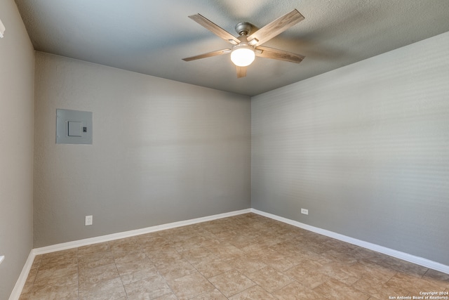 spare room with ceiling fan and electric panel