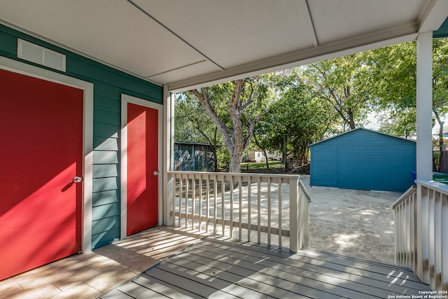 wooden deck with a storage shed