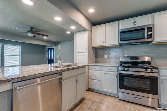 kitchen with ceiling fan, white cabinetry, sink, and appliances with stainless steel finishes