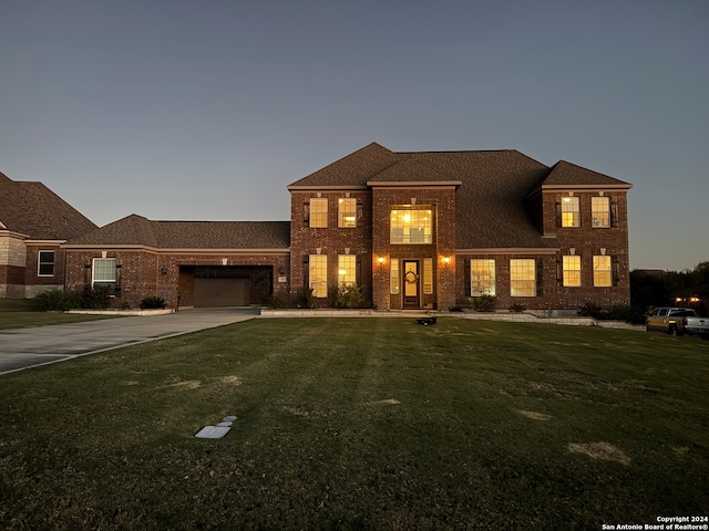 view of front facade featuring a yard and a garage