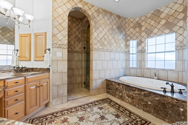 bathroom featuring tile patterned floors, vanity, and a healthy amount of sunlight