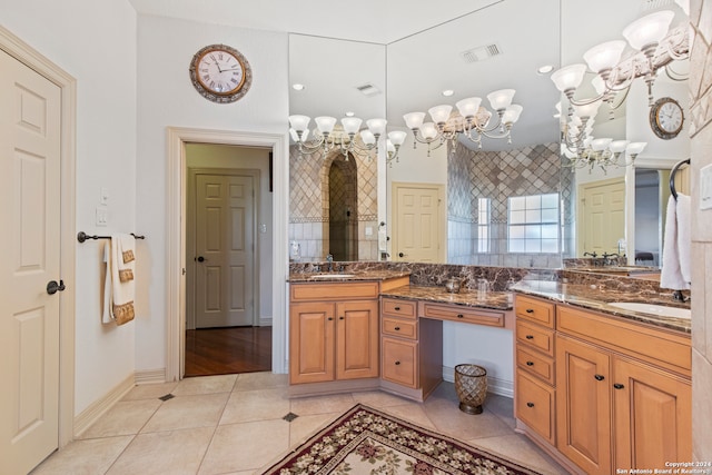 bathroom featuring a chandelier, vanity, and tile patterned floors