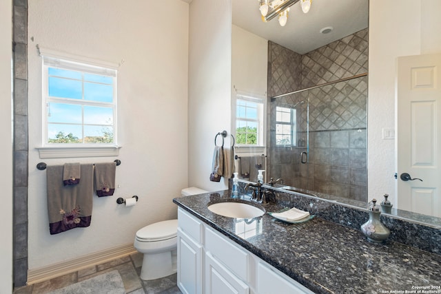 bathroom featuring vanity, toilet, and walk in shower