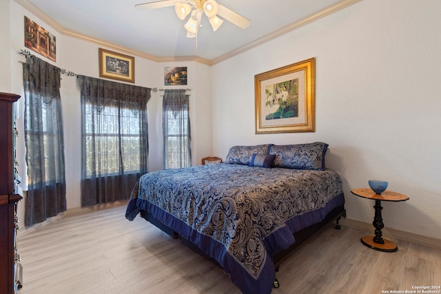 bedroom with ceiling fan, light hardwood / wood-style floors, and crown molding