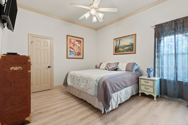 bedroom with light wood-type flooring, ceiling fan, and crown molding