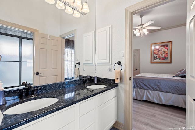 bathroom featuring hardwood / wood-style floors, vanity, ceiling fan, and ornamental molding