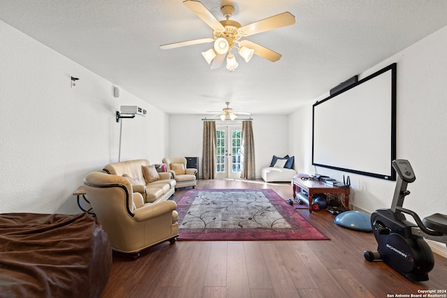 cinema featuring ceiling fan, french doors, hardwood / wood-style floors, and a textured ceiling