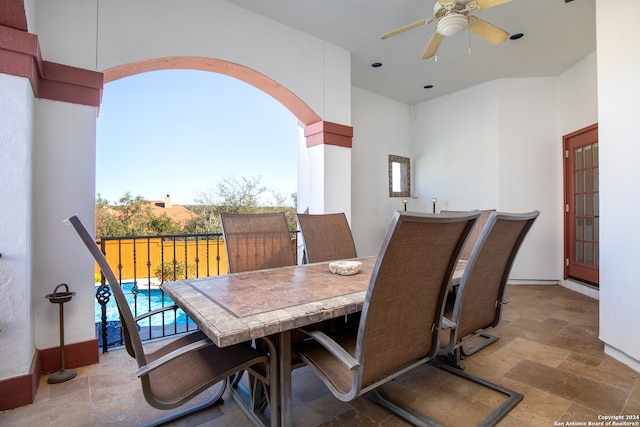 dining space featuring a towering ceiling, ceiling fan, and a healthy amount of sunlight