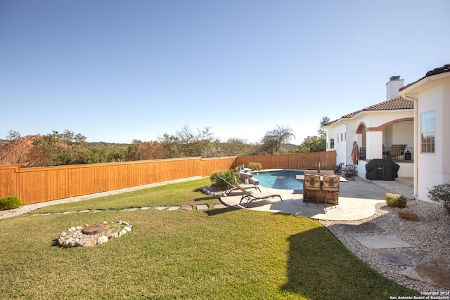 view of yard featuring a fenced in pool and a patio