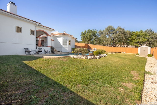 view of yard with a patio area and a storage shed