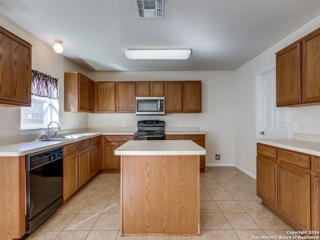 kitchen with black appliances, a kitchen island, light tile patterned flooring, and sink