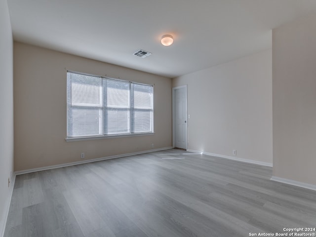 spare room with light hardwood / wood-style floors