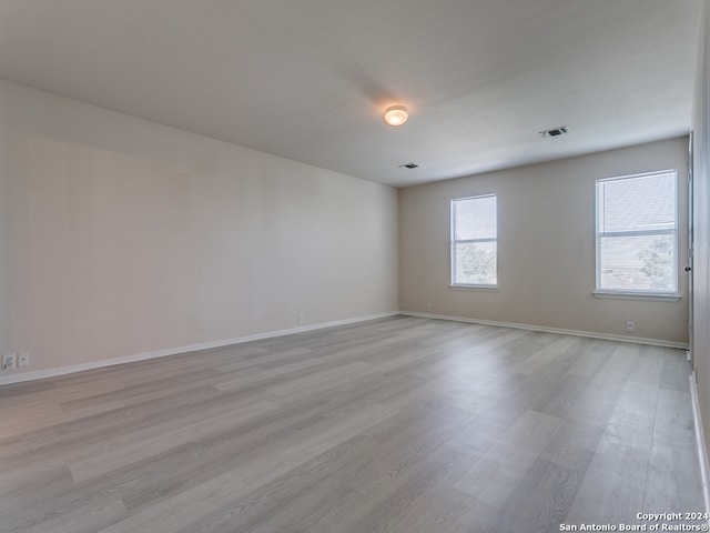 unfurnished room with light hardwood / wood-style floors