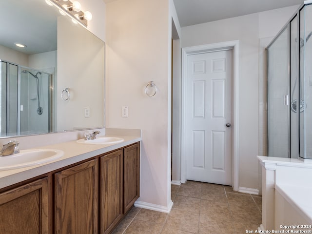 bathroom featuring tile patterned flooring, vanity, and an enclosed shower