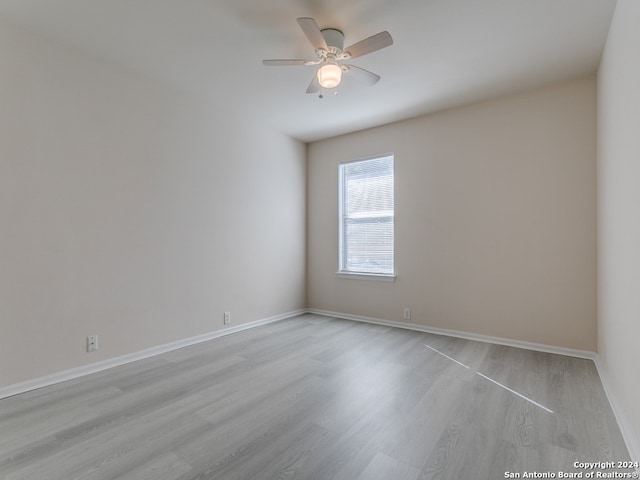 empty room with light hardwood / wood-style floors and ceiling fan