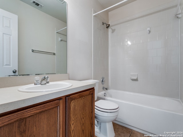 full bathroom featuring tile patterned flooring, vanity, toilet, and tiled shower / bath combo