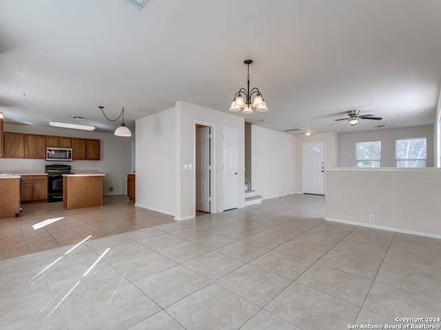 unfurnished living room with ceiling fan with notable chandelier, light tile patterned flooring, and sink