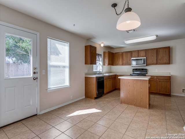 kitchen with pendant lighting, black appliances, sink, light tile patterned floors, and a kitchen island