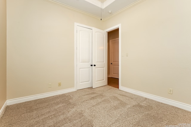 carpeted empty room with ornamental molding