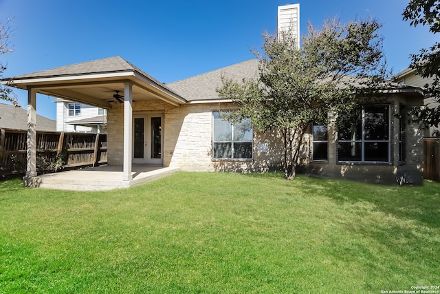 back of property featuring a lawn, ceiling fan, french doors, and a patio