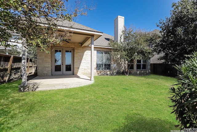 back of house with french doors, a yard, and a patio